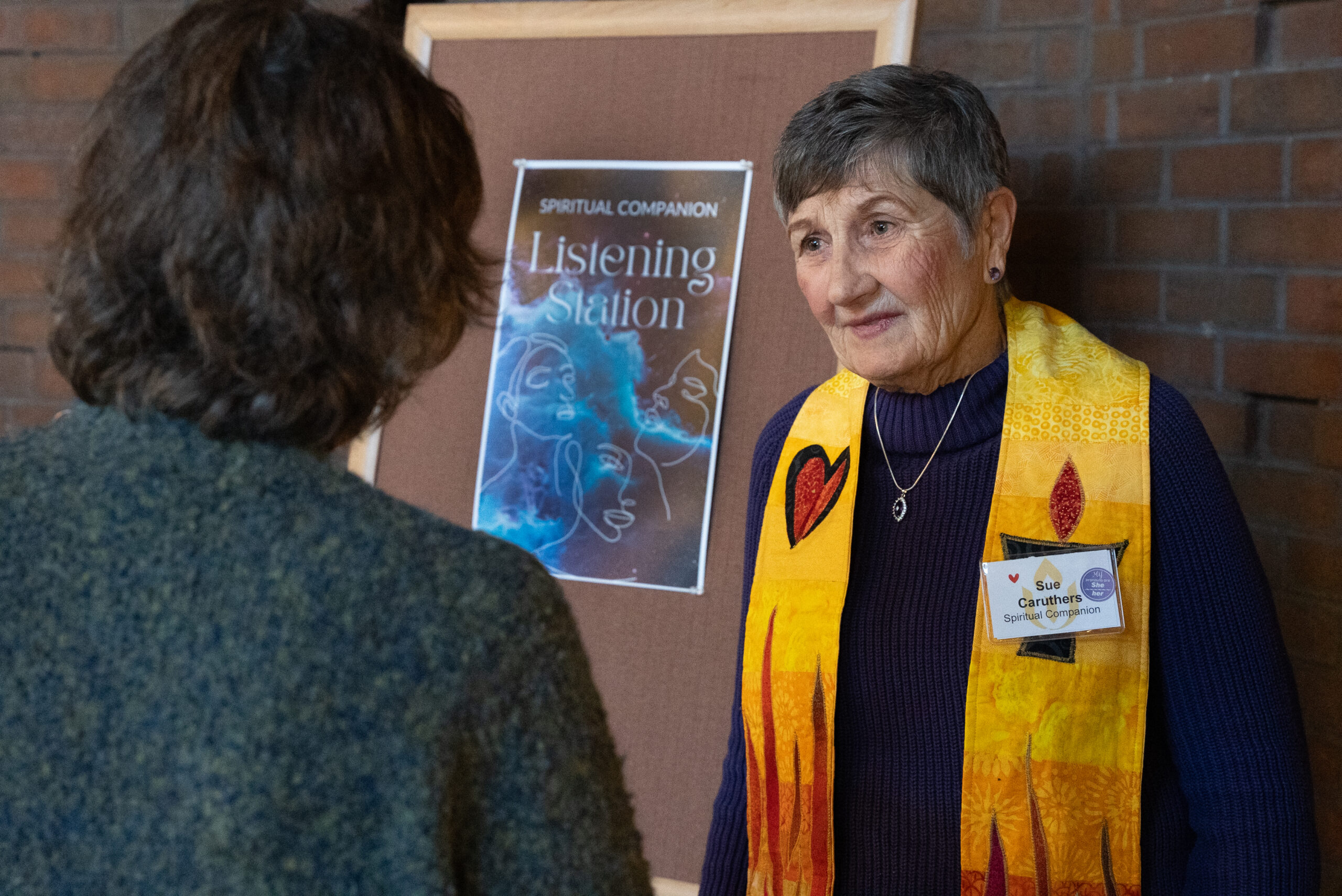 One of our spiritual companions chats with a congregant at our listening station.
