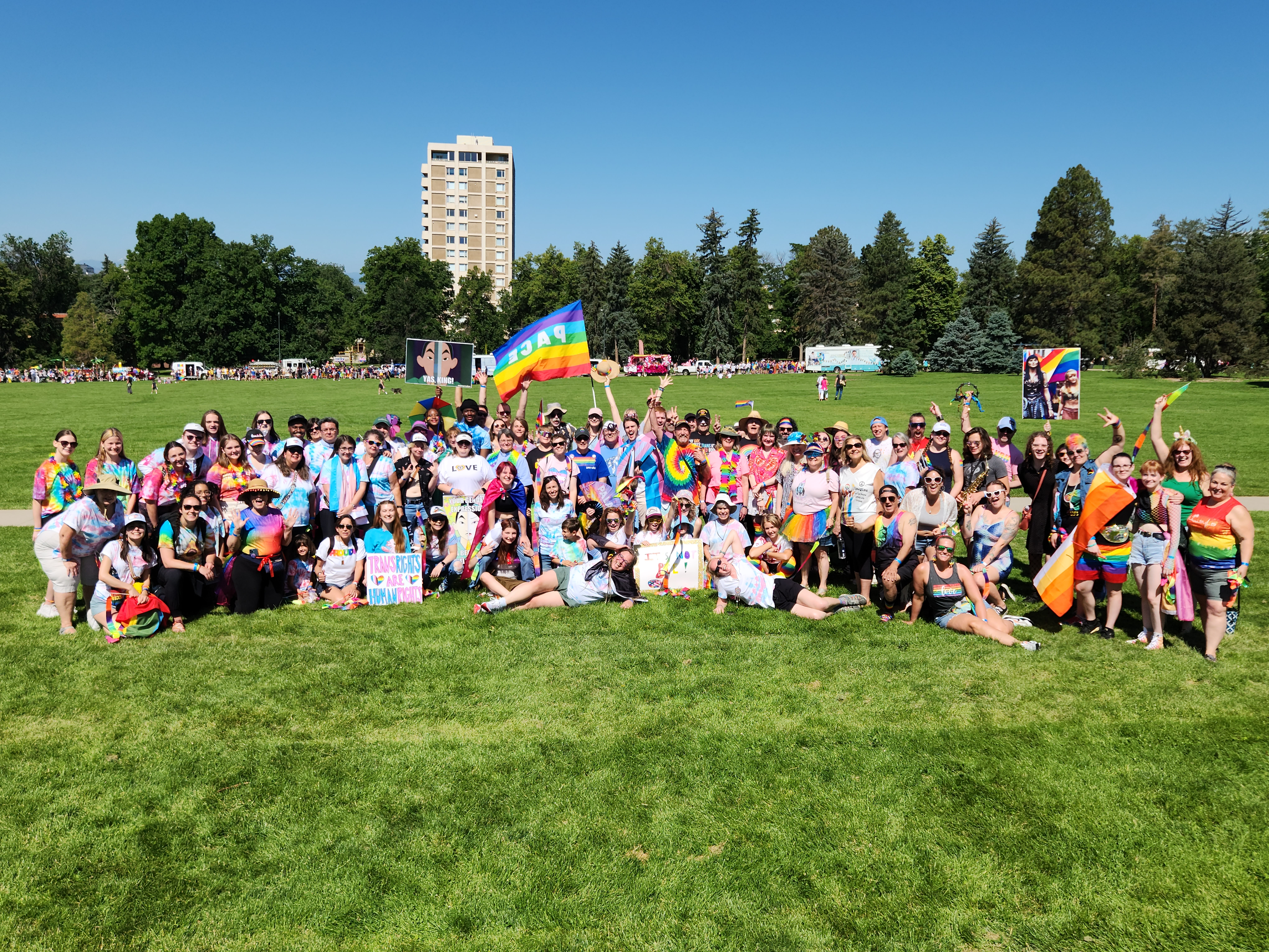A group photo taken of Common Flame members and friends at a Denver Pride festival.