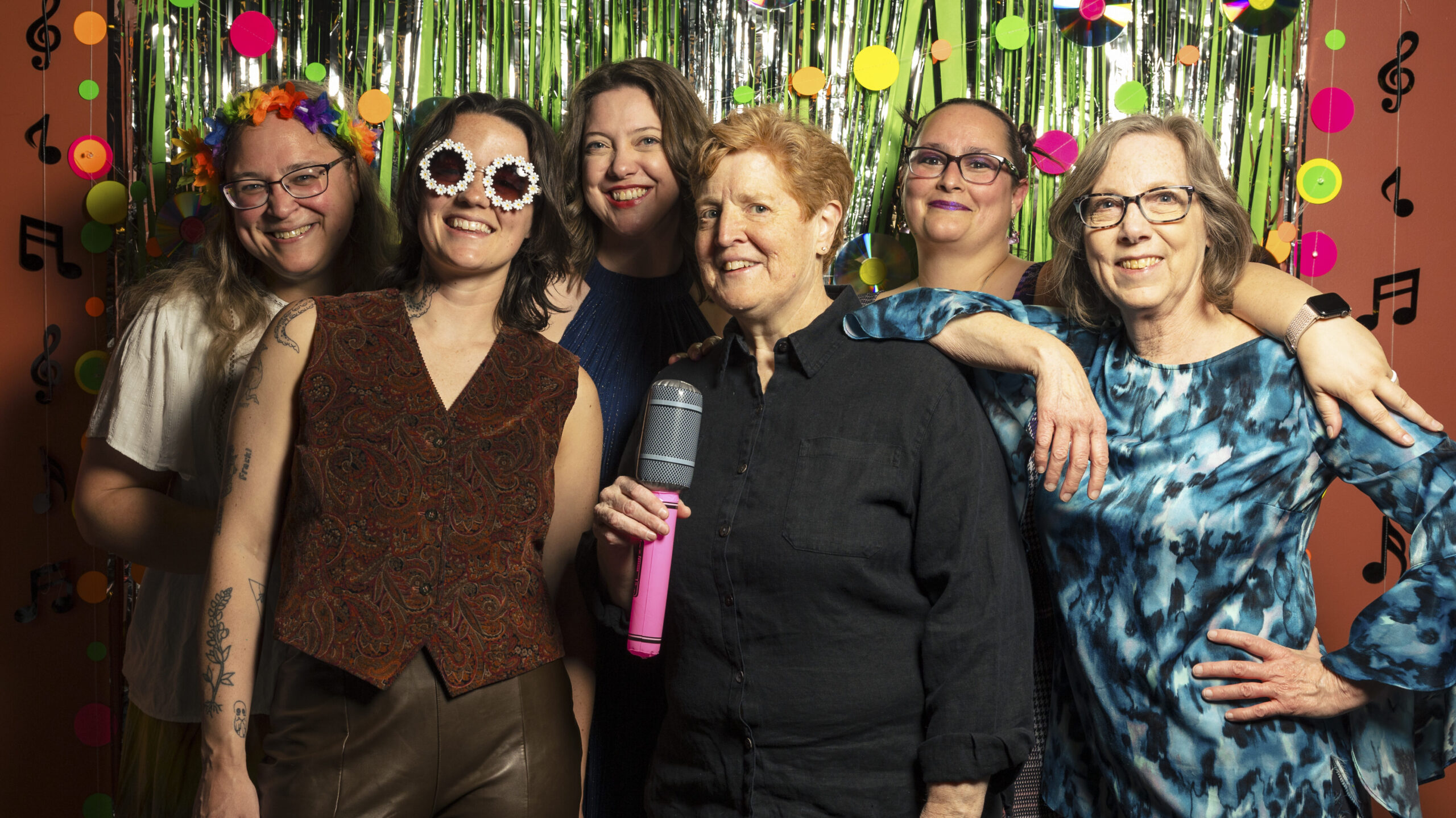 Common Flame staff pose for a team photo at the 2026 Spring Dance: Dancing through the Decades